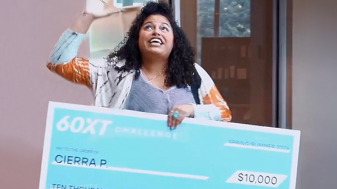 60XT grand prize winner holding her large check.