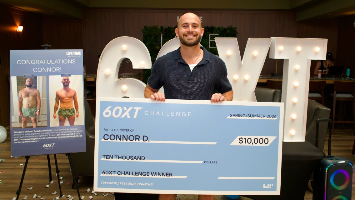 60XT grand prize winner holding his large check.