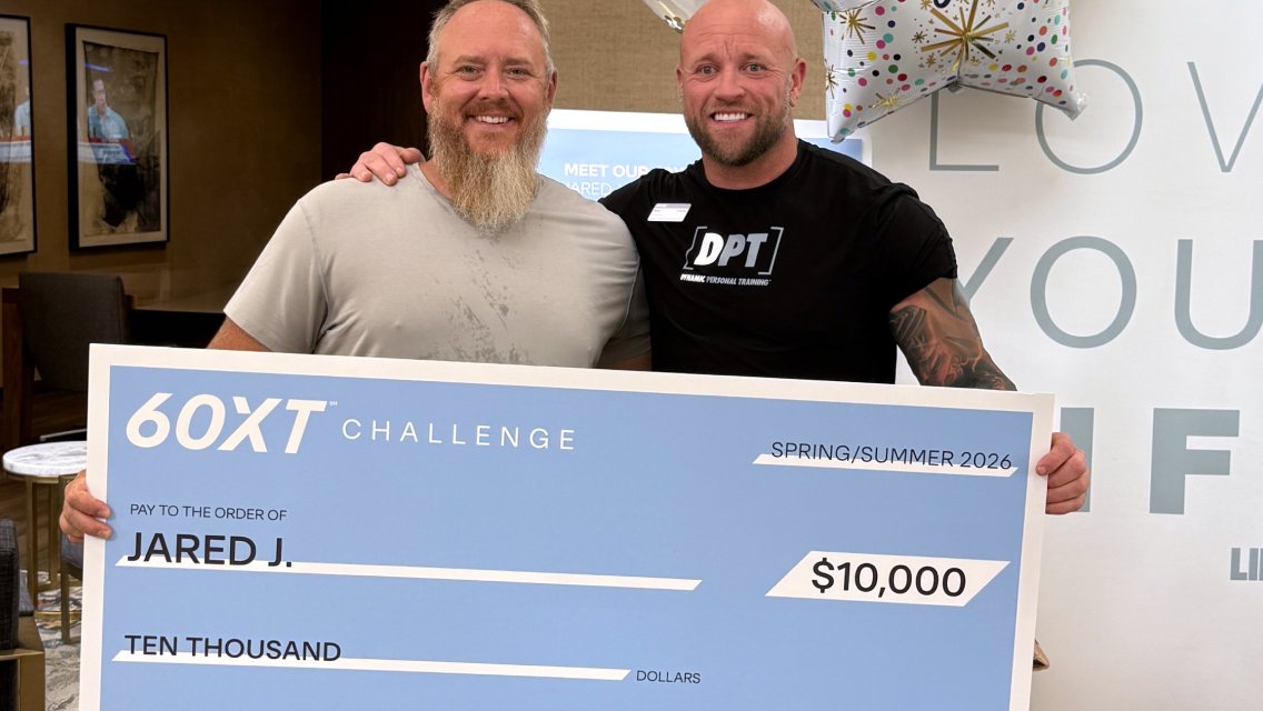 60XT grand prize winner holding his large check.