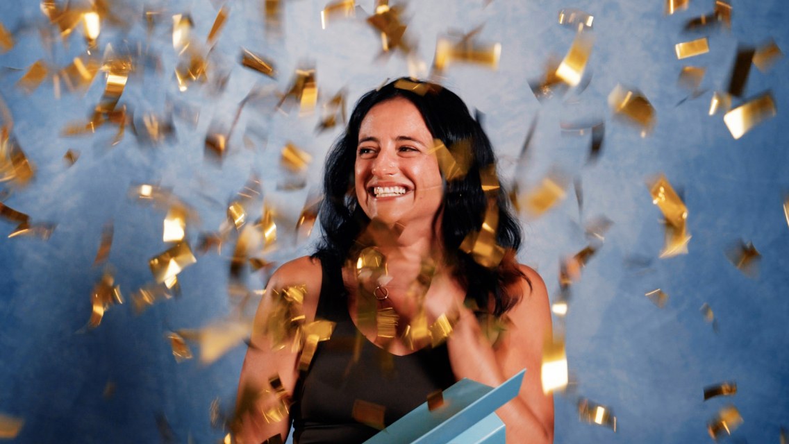 Woman with confetti all around her.
