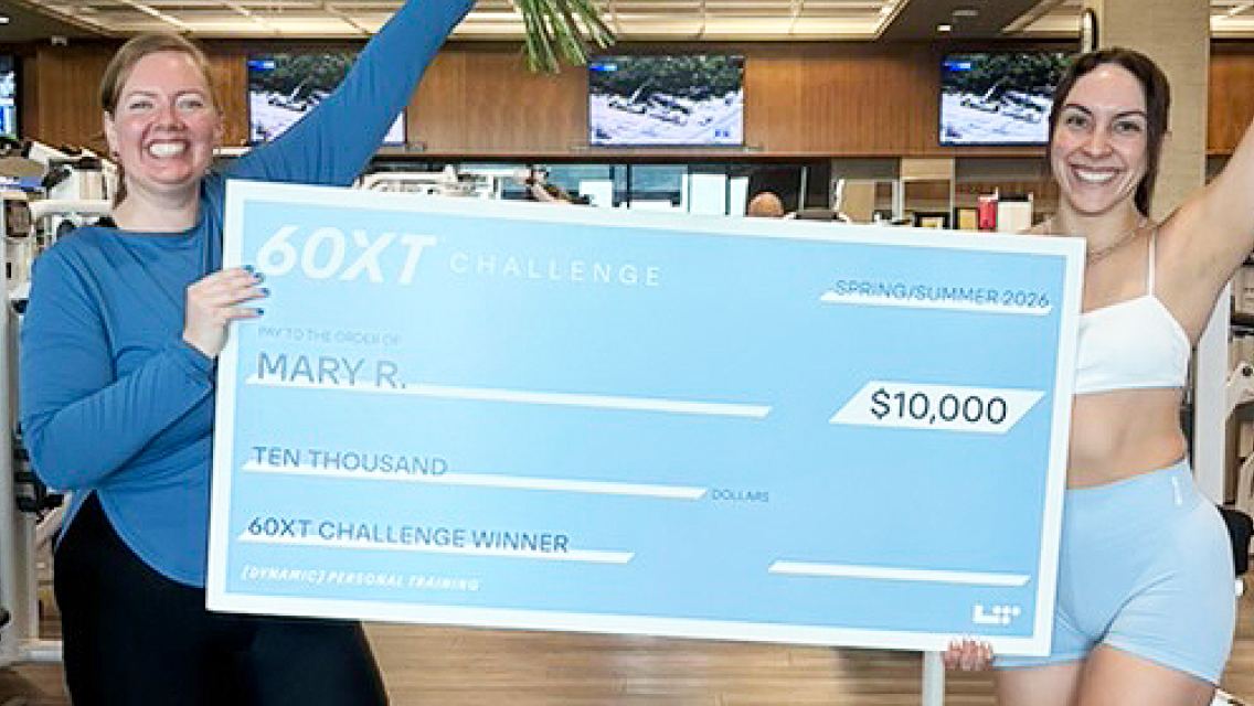 60XT grand prize winner holding her large check.