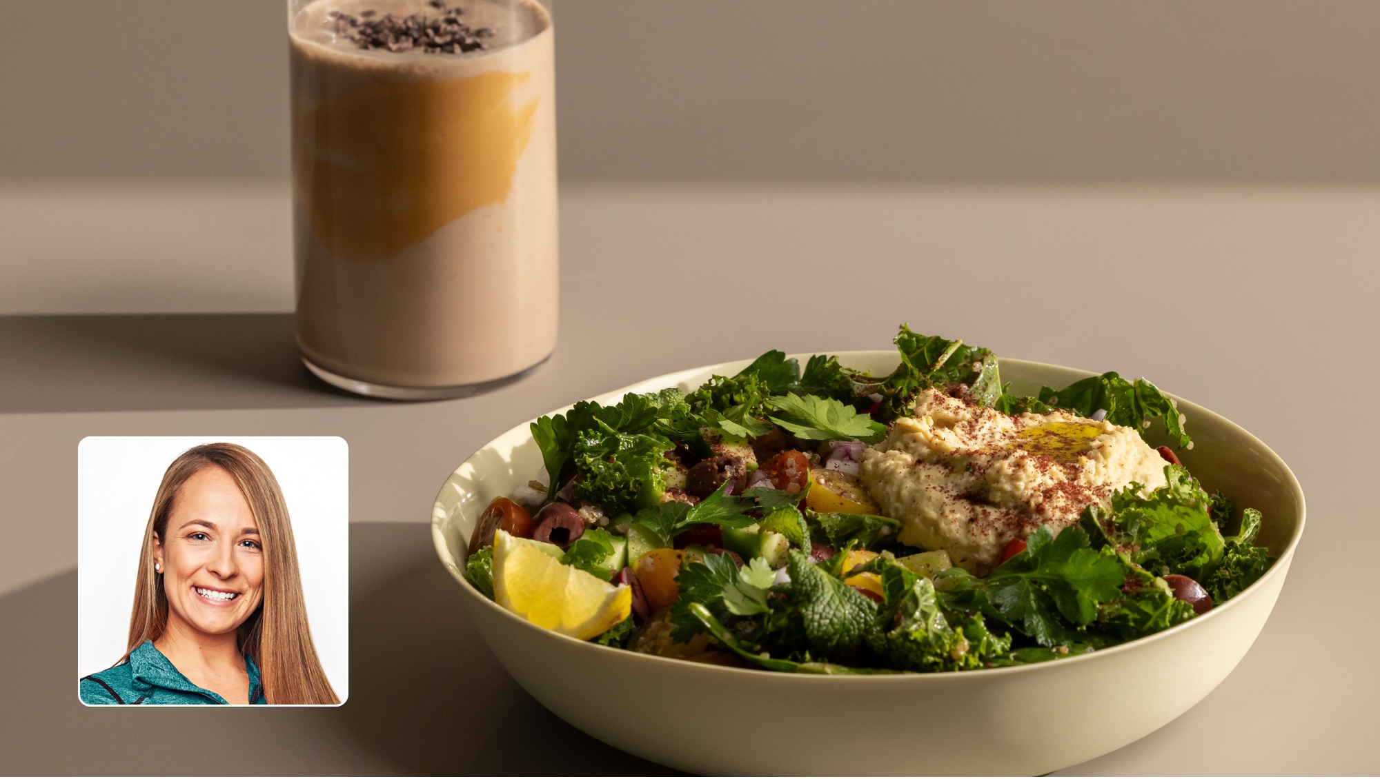 Plate of salad and drink on a table.
