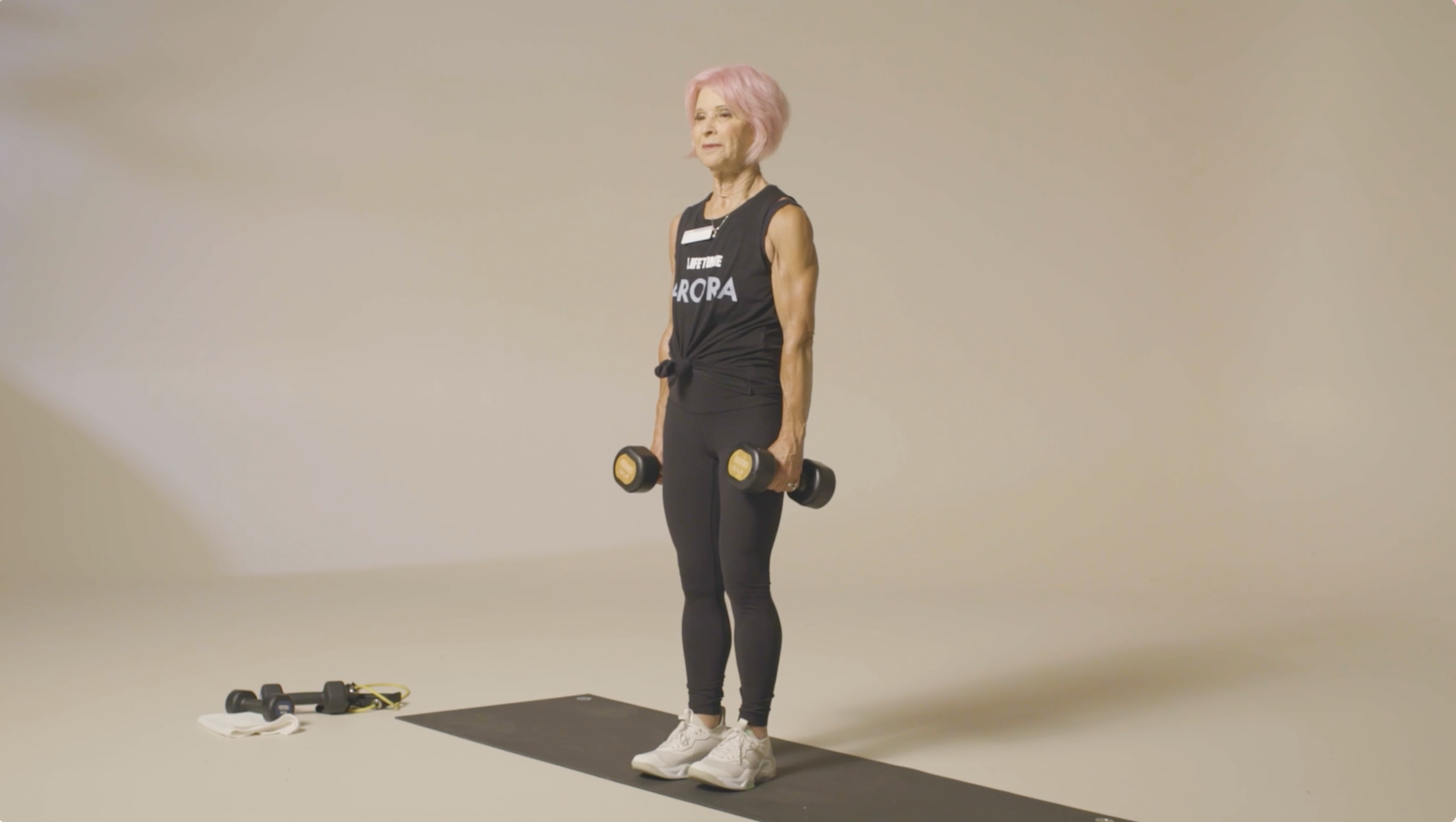 Trainer holding two dumbbells.