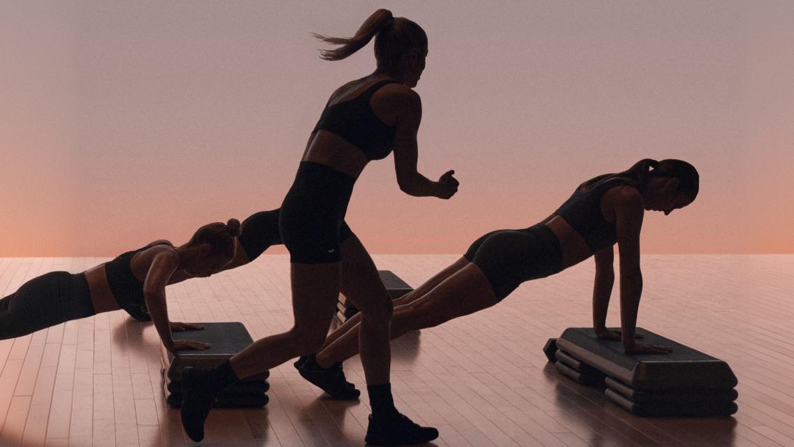 People doing strenth moves in shred class.