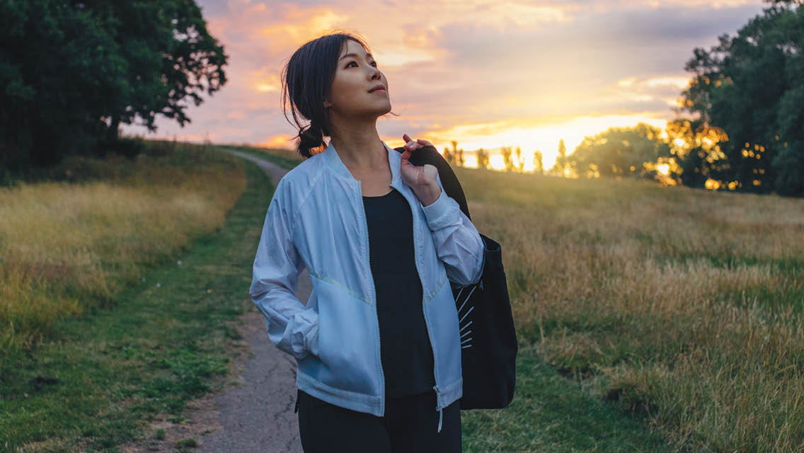 a woman walks on a country road