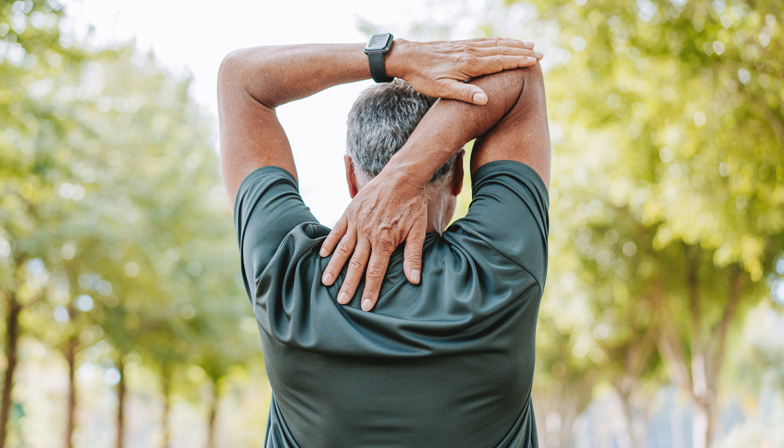 a senior man stretches