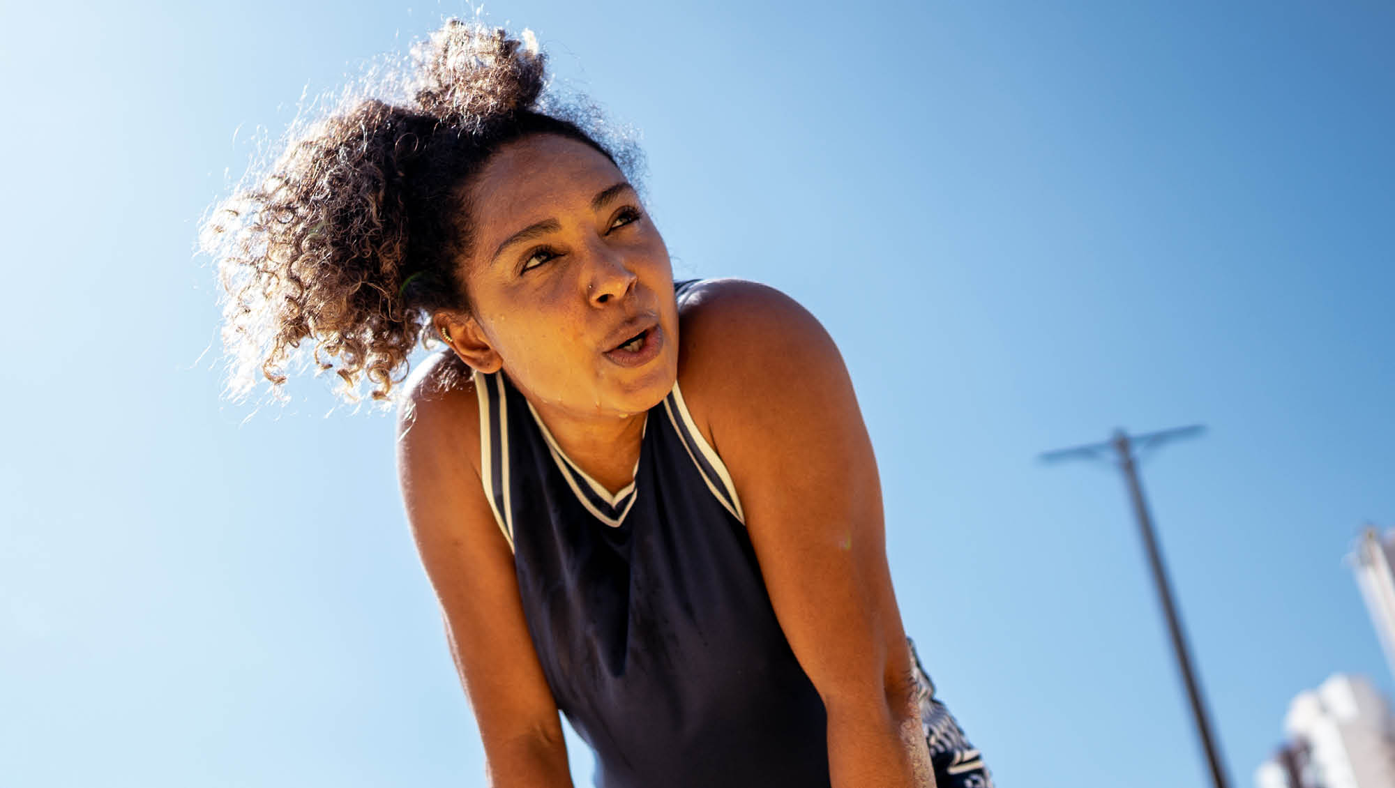 a woman stops while exercising to catch her breath