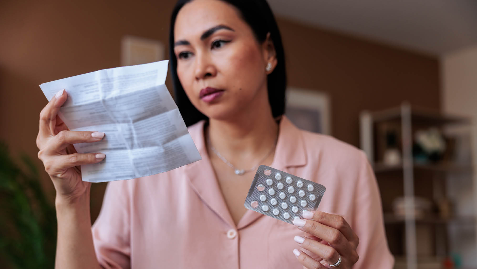 a woman reads instructions for pills