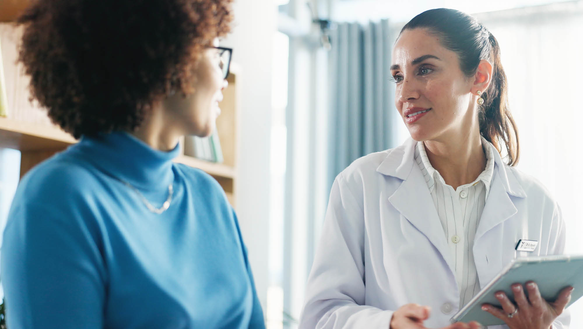 a woman talks with her physician