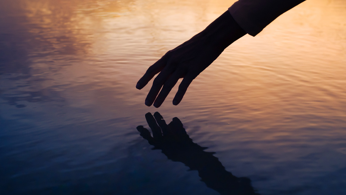 a hand touching water
