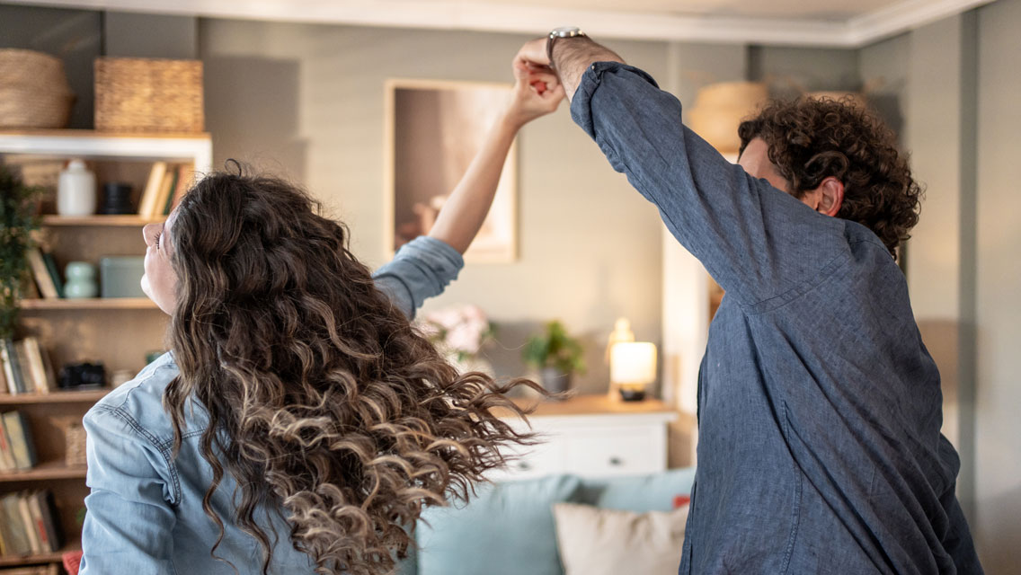 a couple dances in their living room