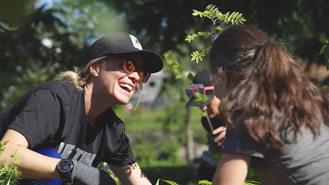 Woman planting with friends.