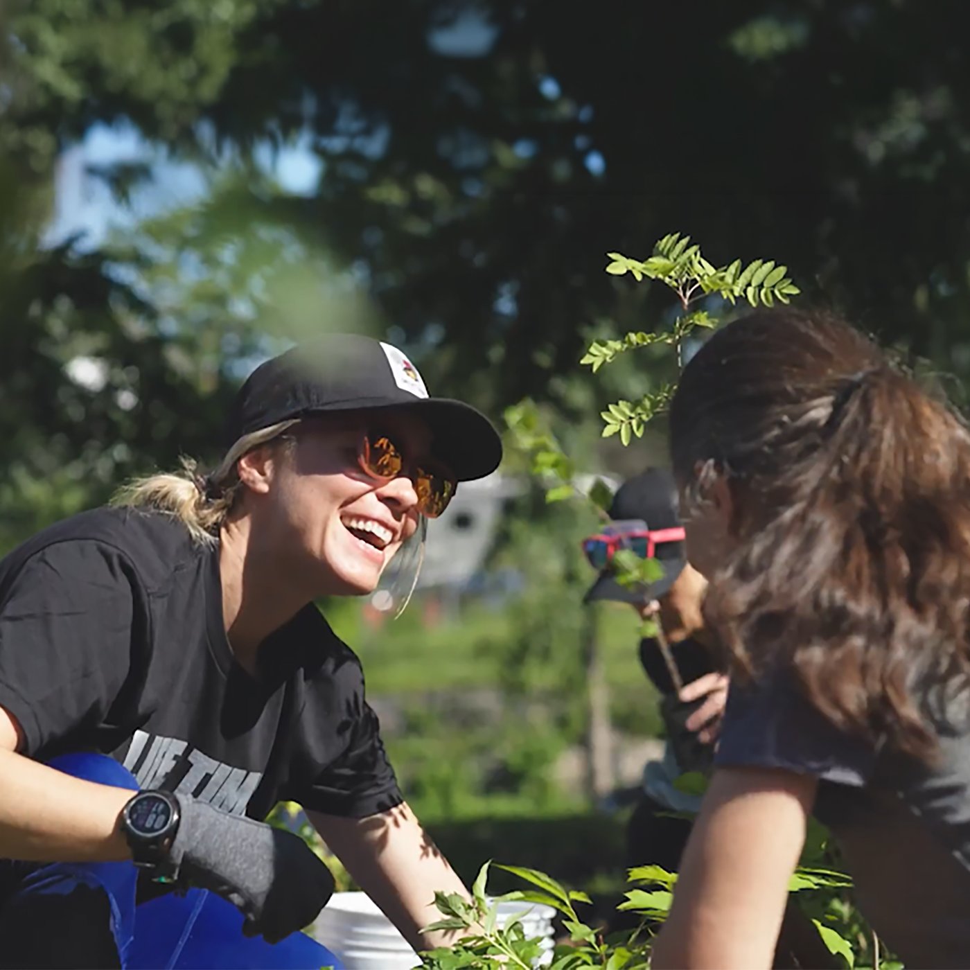 Woman planting with friends.