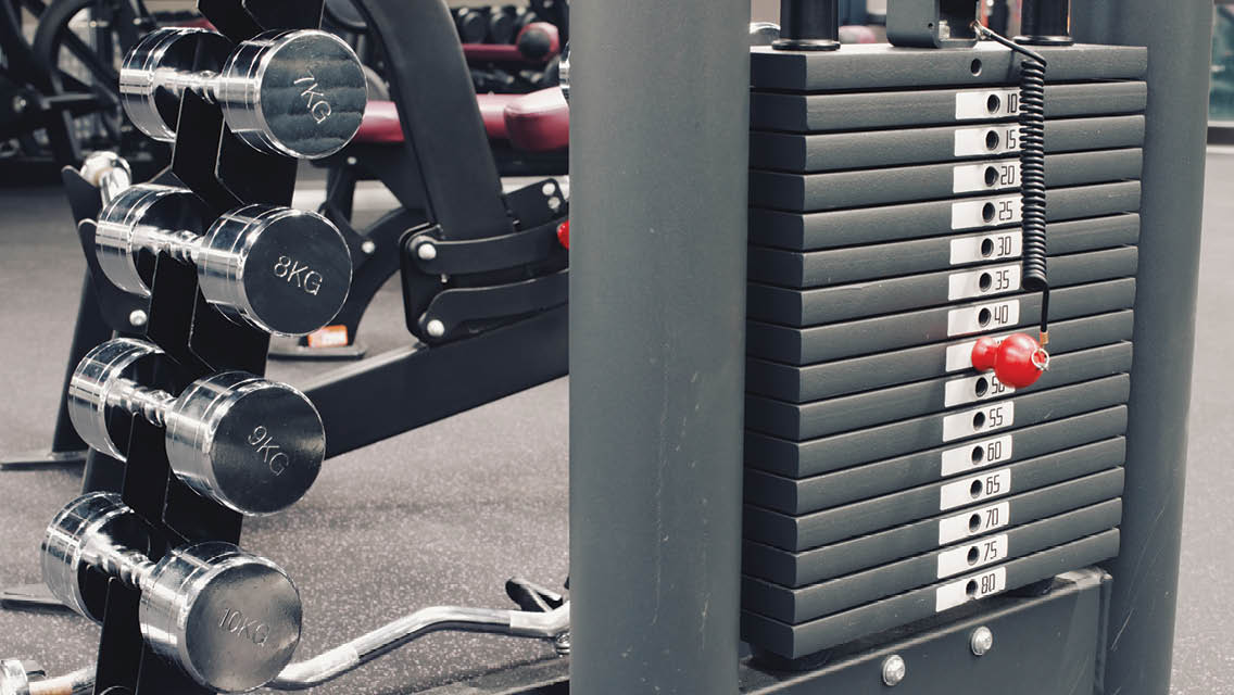 a rack of free weights and a weight machine