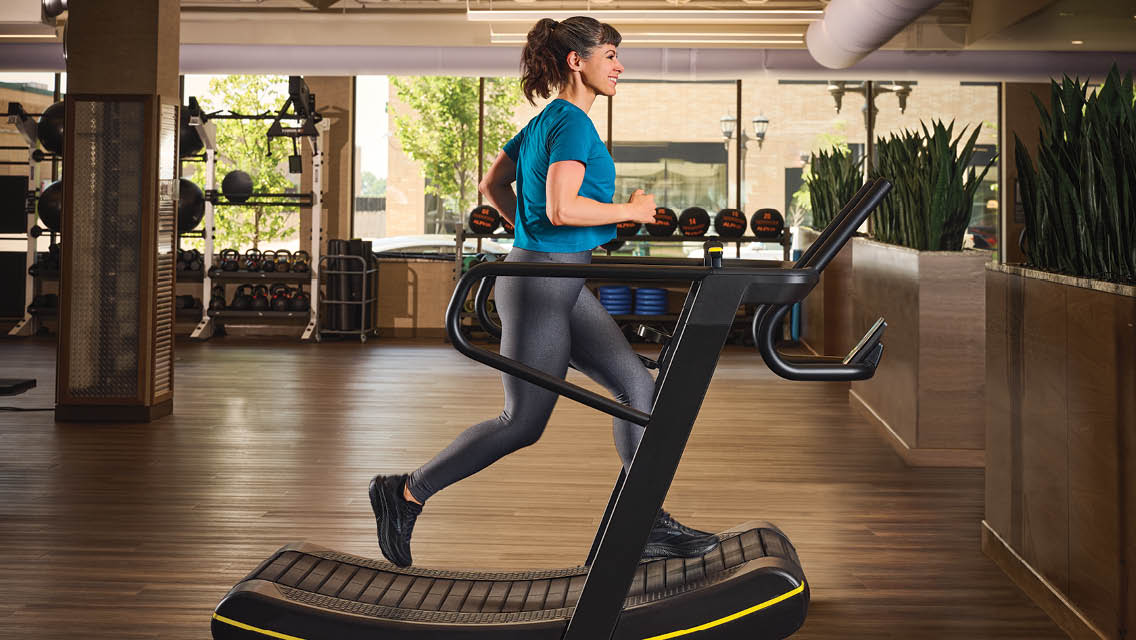 a woman jogs on a treadmill