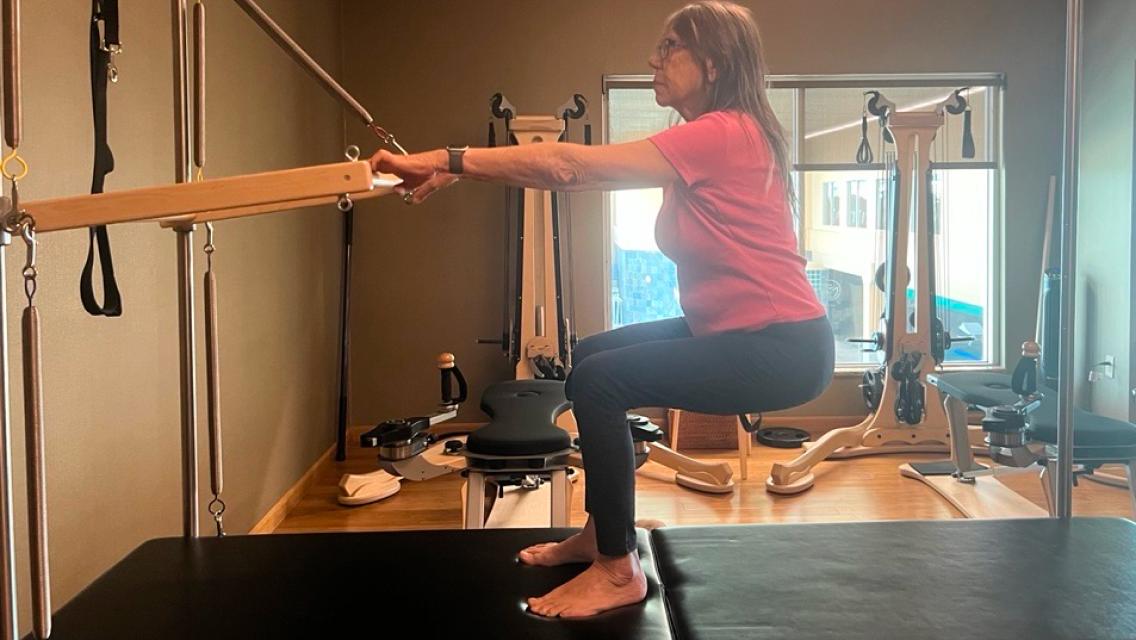 Life time member doing pilates.
