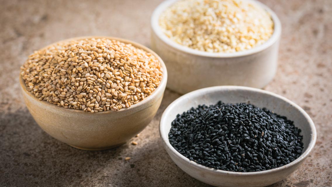 bowls of black, brown, and white sesame seeds
