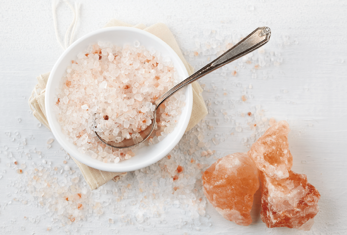 "Himalayan Pink Rock Salt in bowl on table, can be used in food or in bathtub"