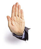 Studio shot of a hand coming out from a broken sheet of paper  making stop sign a lot of copy space 