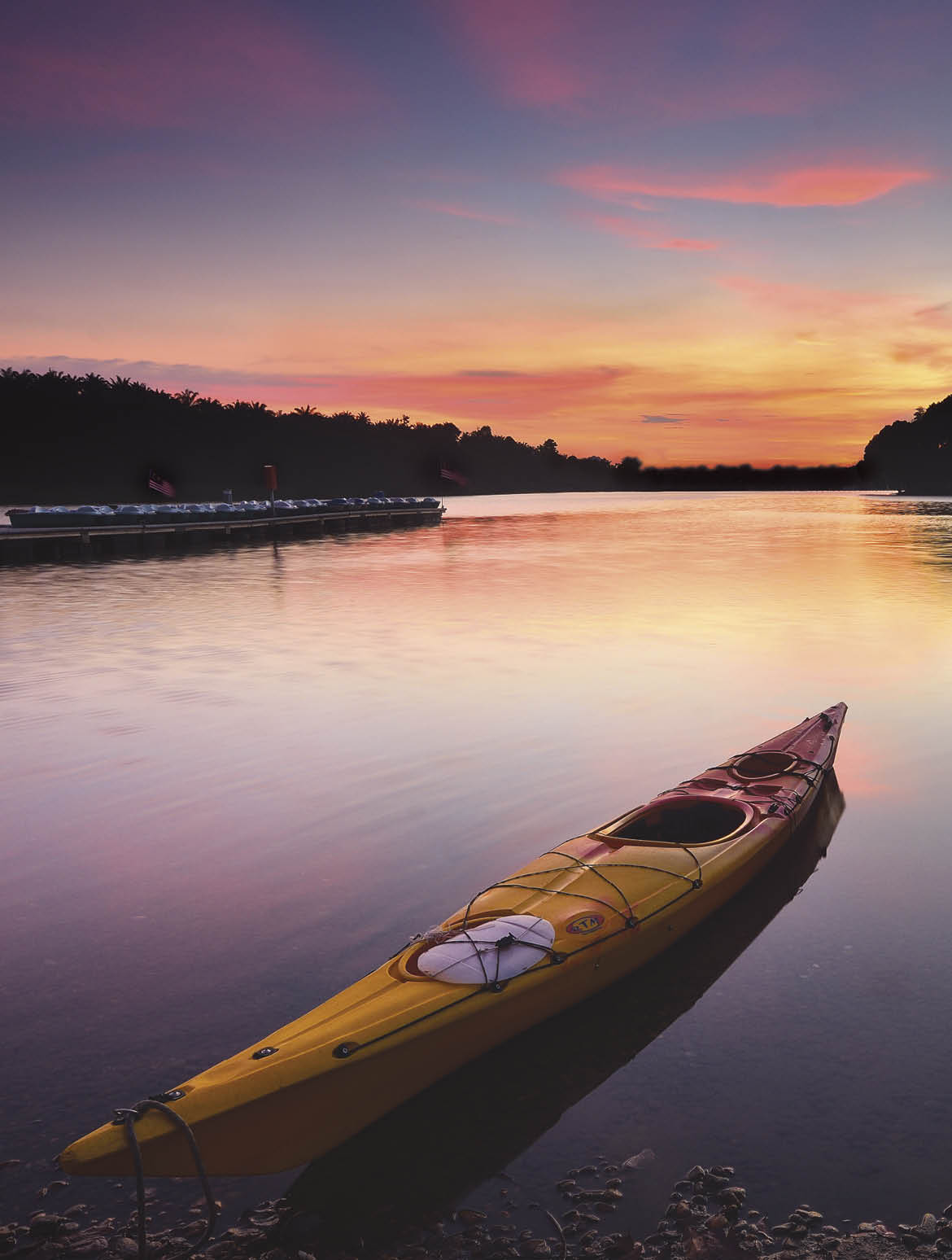 Canoe on water during Sunset