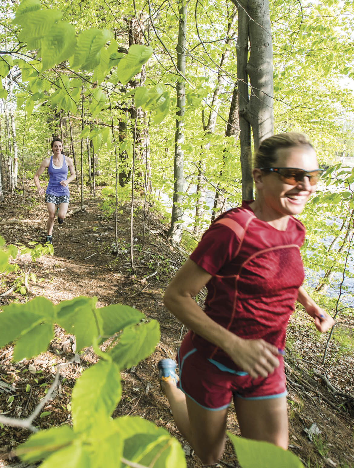 Two Women Trial Running In Forest Near River