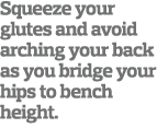 Squeeze your glutes and avoid arching your back as you bridge your hips to bench height 
