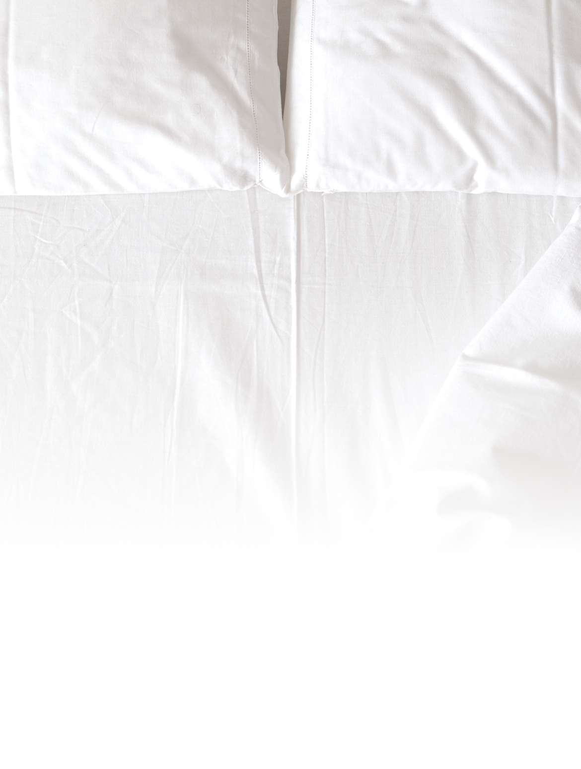 Top view of white bedding sheet placed on bed 
