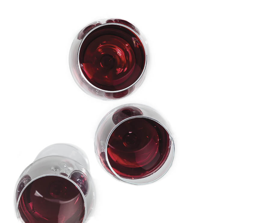top view of red wine in glasses arranged isolated on white