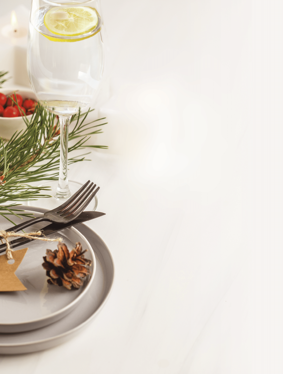 Christmas beautiful table setting with champagne and candles  Christmas postcard  Light background, christmas concept 