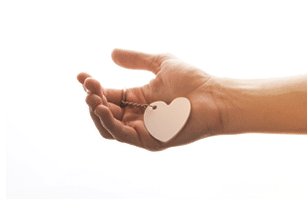 Heart shaped white object in hand on white background