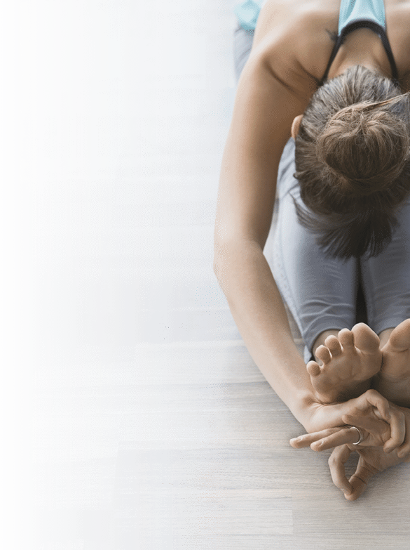Woman in seated forward bend practicing mudra yoga