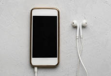 Mobile Phone and headphones on white background