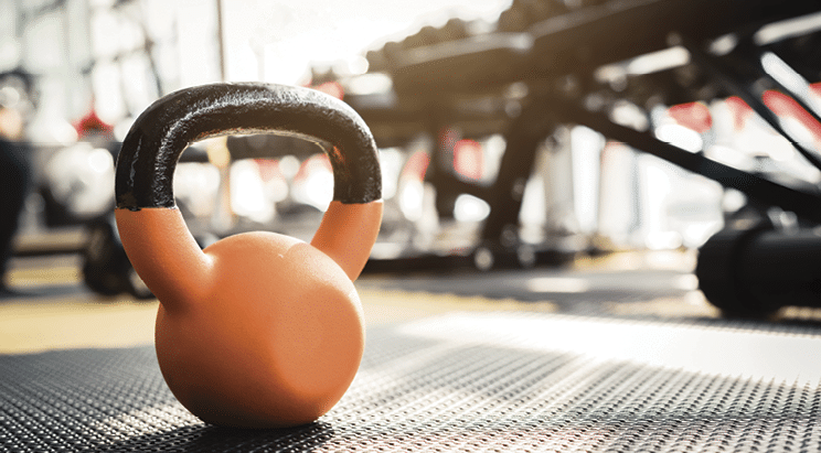 dumbbells and barbells with set of equipment for weightlifting in gym