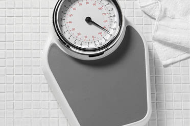  Bathroom scales  with a white bath robe on a tiles background  Copy spaceClick on the link below to see more of my related images  