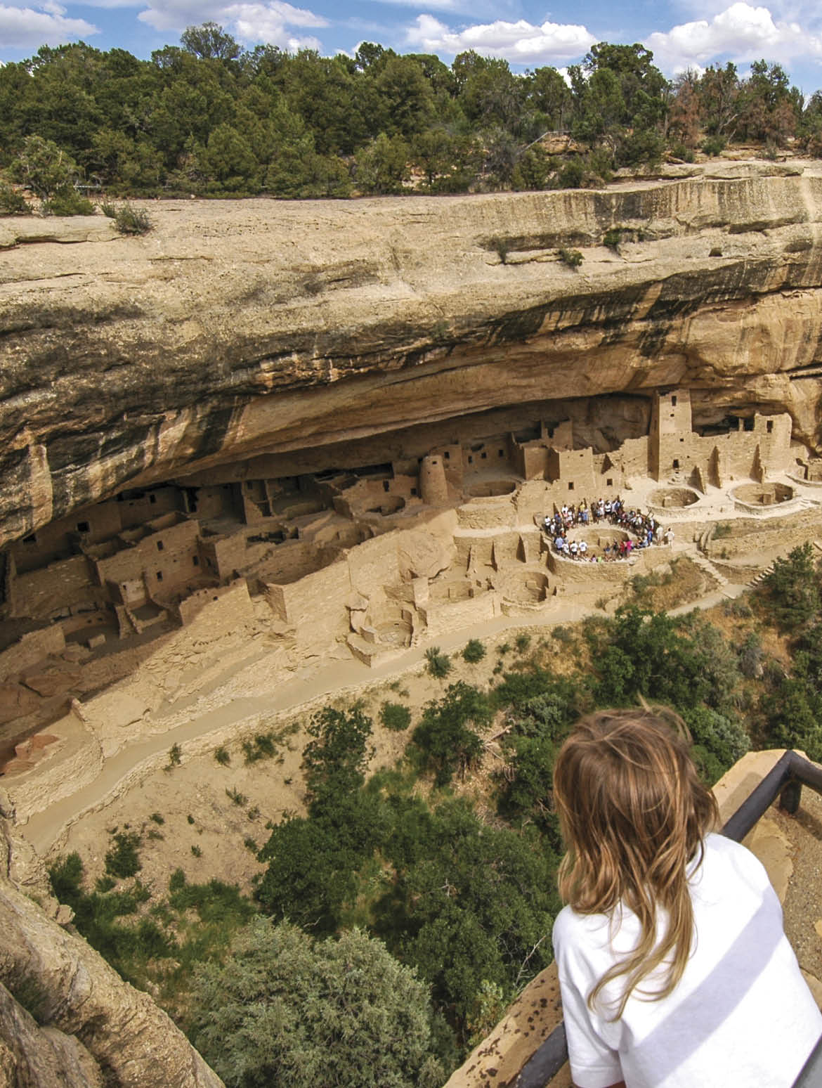 Young boy looking down of the fanous Cliff Palace in Mesa Verde National Park  Colorado  American Sountwest 
