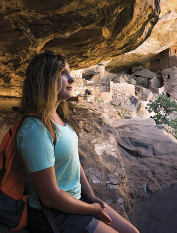 Teenage girl lost in thought while visitng the Cliff Palace cliff dwelling inhabited until the 13th century by  Ancient Puebloans  Anasazi   Mesa Verde National Park  Colorado  USA
