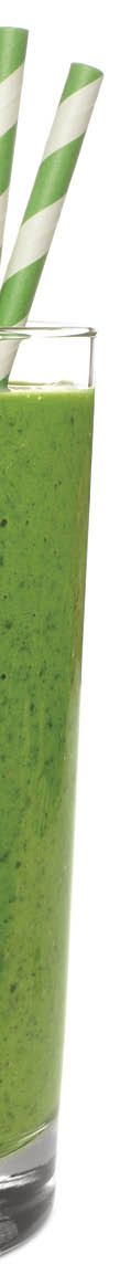 Healthy green smoothie in a glass with paper straws isolated on a white background
