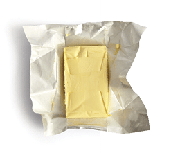 Piece of butter isolated on white background, top view