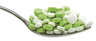 dose of pills in a spoon on a white background