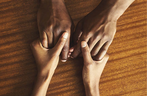 Closeup shot of two unrecognizable people holding hands in comfort