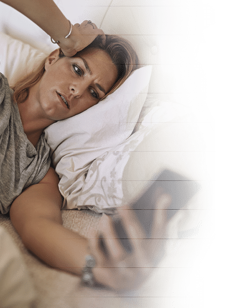 Cropped shot of an attractive  woman in bed looking at her phone in worry at home