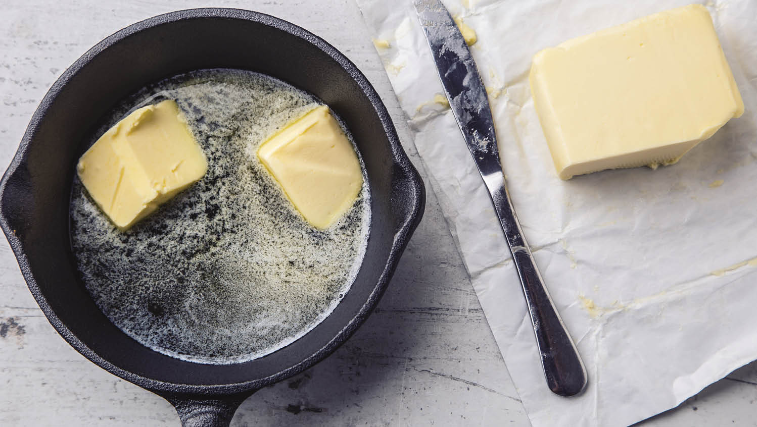 Butter  Pieces of butter in the hot pan top view 