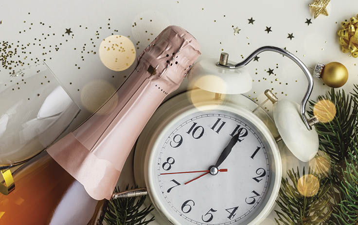 Christmas or New Year composition on white background with retro alarm clock, bottle of champagne, glasses and Christmas decorations - stars, confetti, balls and gift boxes, top view, flat lay