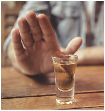 Cropped image of man showing stop gesture and refusing to drink