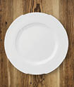 Table setting on rustic wood background - plate  fork and knife