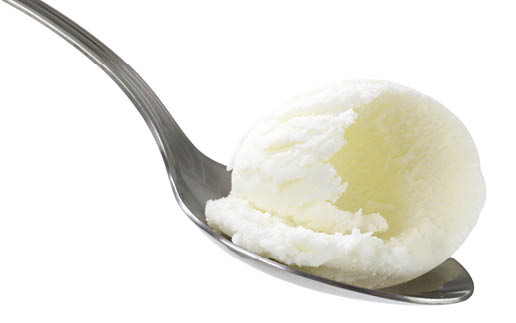 White ice cream on metal spoon