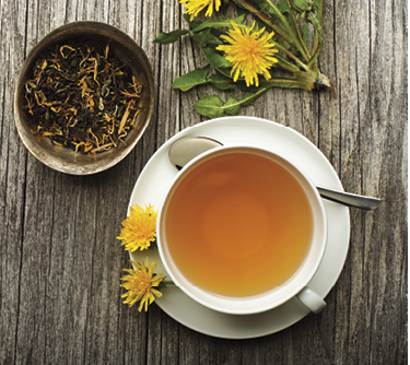 Cup of healthy dandelion tea on wooden background  Herbal medicine 