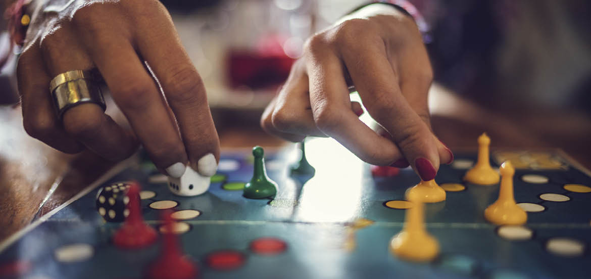 Close up of unrecognizable women playing board game 