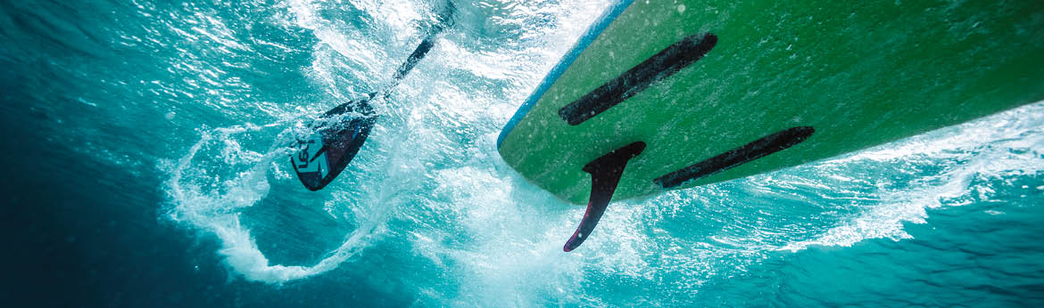 A shot of a paddleboard taken underwater 