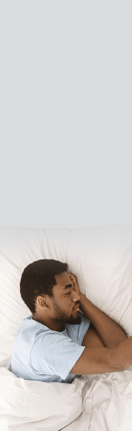 Lonely black man sleeping in bed and missing his partner  touching empty pillow and sorrow  top view  free space